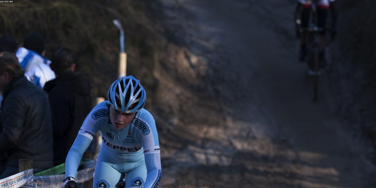 A cyclist extending an arm to signal a turn to traffic